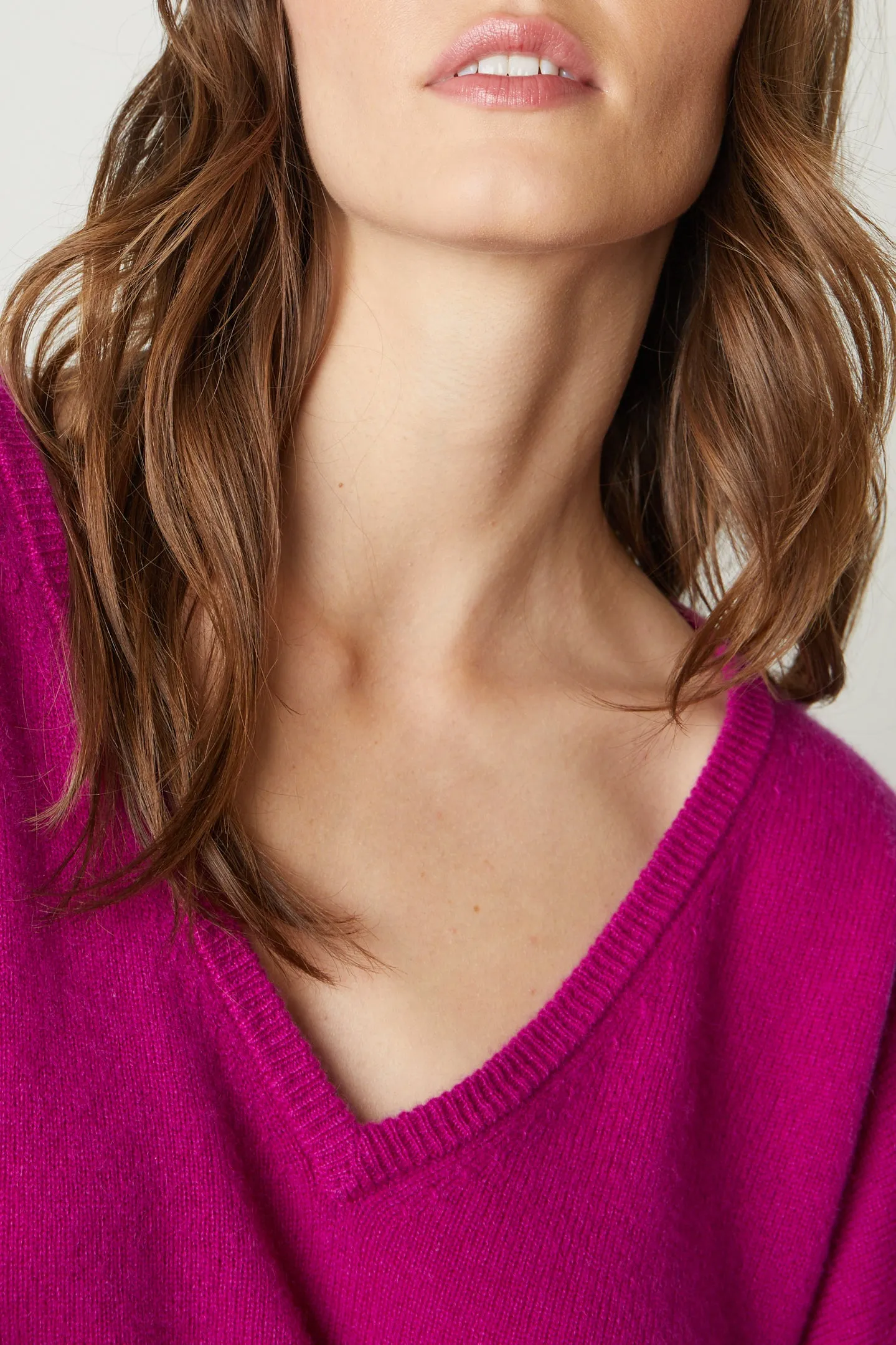 AMIKA CASHMERE V-NECK SWEATER IN MAGENTA