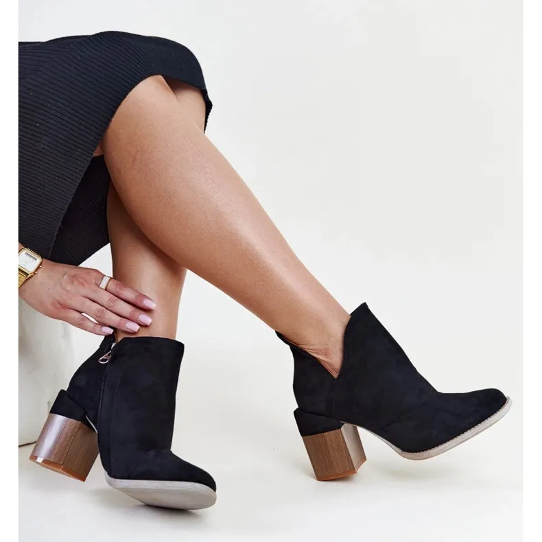 Black asymmetrical insulated ankle boots by Nadica