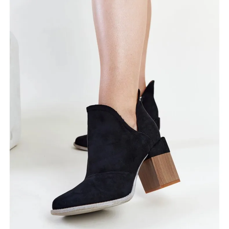 Black asymmetrical insulated ankle boots by Nadica