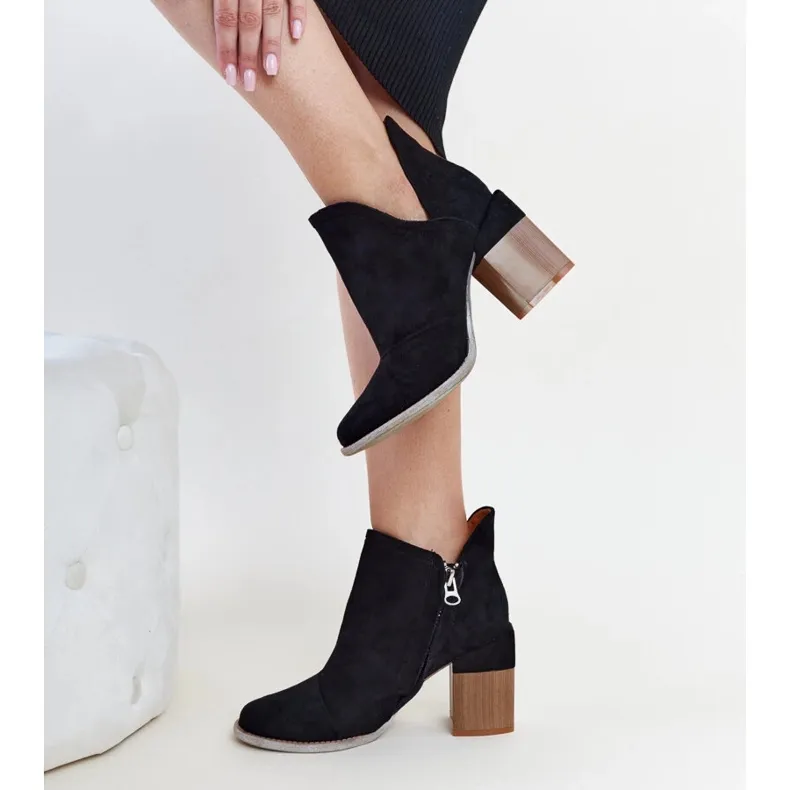 Black asymmetrical insulated ankle boots by Nadica