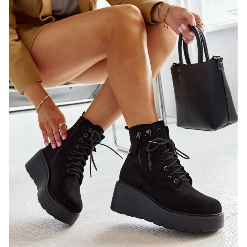 Black insulated suede wedge boots by Safiya